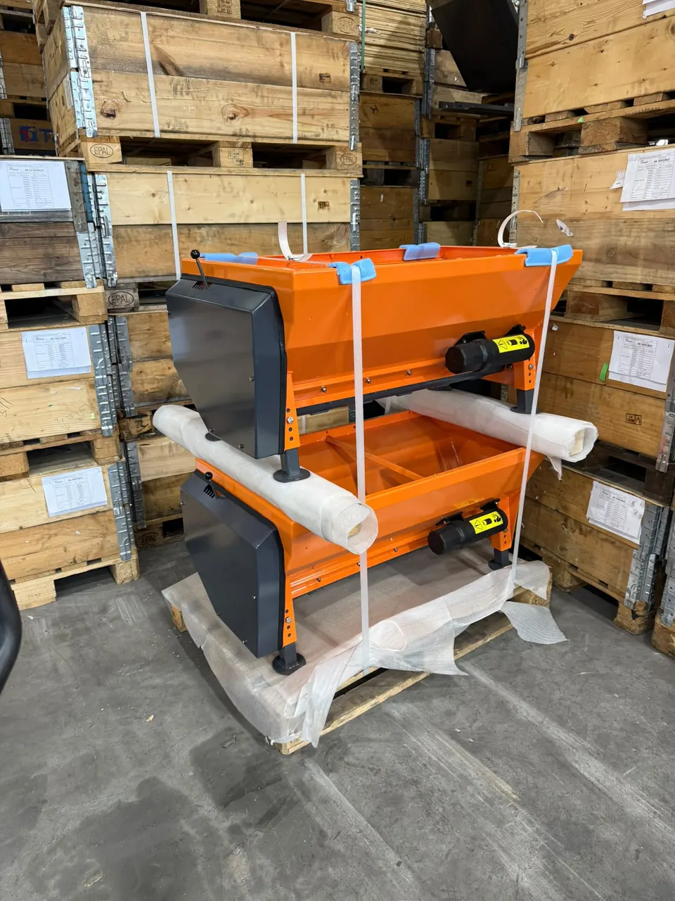 Orange-painted housings packed on pallets