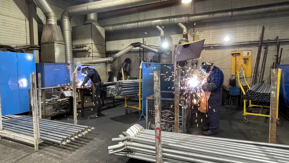 Welders at manual welding stations