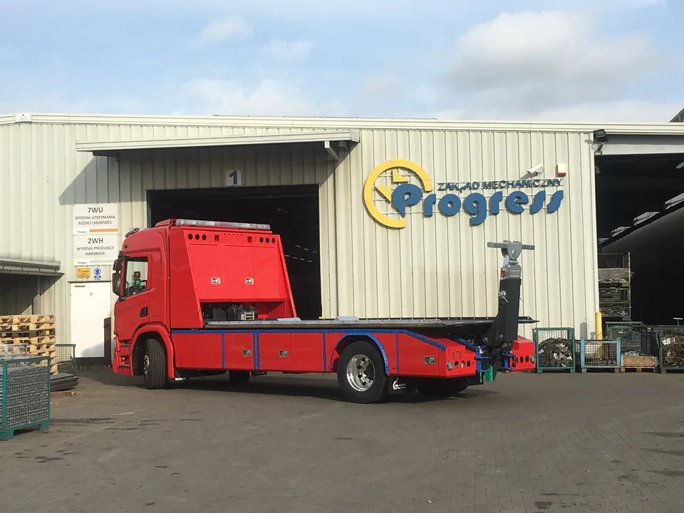 Truck in front of a Progress hall